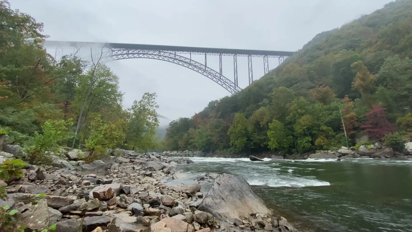 The New River Gorge Bridge arching over the forested New River canyon